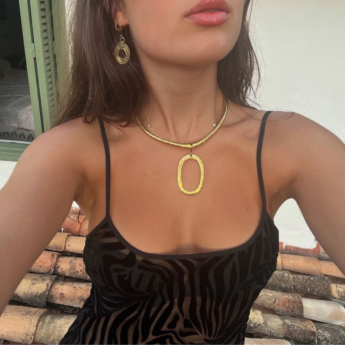 Woman wearing Eclipse earrings from Bambaz Kenyan artisan jewelry collection