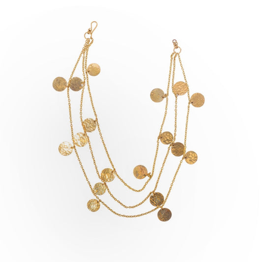 Multi-strand gold chandelier necklace with hammered disc pendants arranged in three cascading layers, displayed flat to highlight the delicate chain work and textured circular medallions
