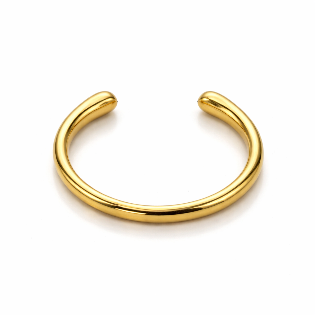 Gold open cuff bracelet on a white background